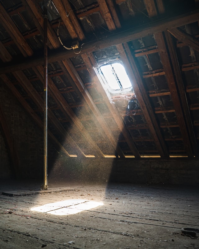 attic with sunlight shining through window